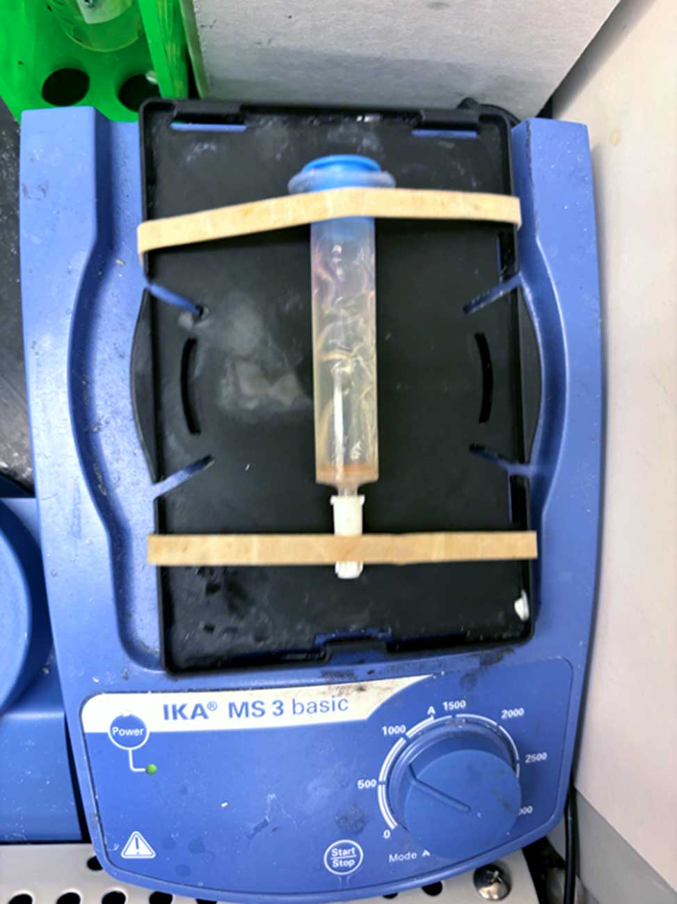Resin in SPPS cartridge on a vortex mixer equipped with microplate tray